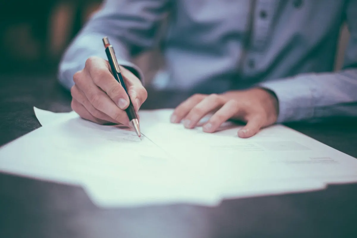 A hand writing on an application form